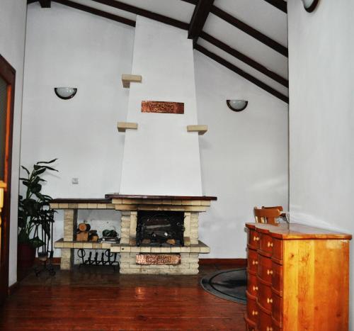 a living room with a fireplace and a table at Victoria Hotel Borovets - Free Parking in Borovets