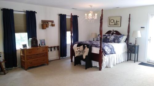 a bedroom with a bed and a chandelier at Marvels on the creek in East New Market