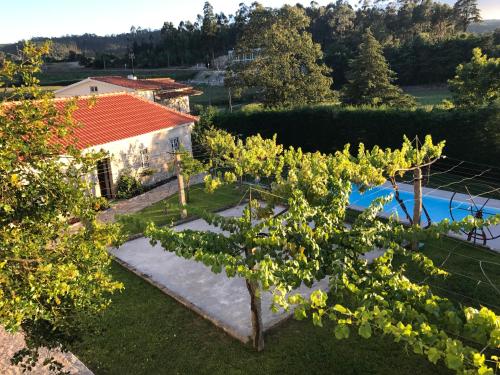 an aerial view of a villa with a tree at Quinta do Giestal in Aborim