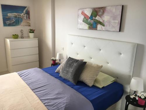 ロス・クリスティアーノスにあるAmazing View in Los Cristianosのベッドルーム1室(青いシーツと枕のベッド1台付)