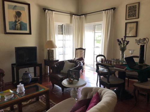 a living room with a couch and chairs and a table at Quinta Nova do Almeida in Alcobaça