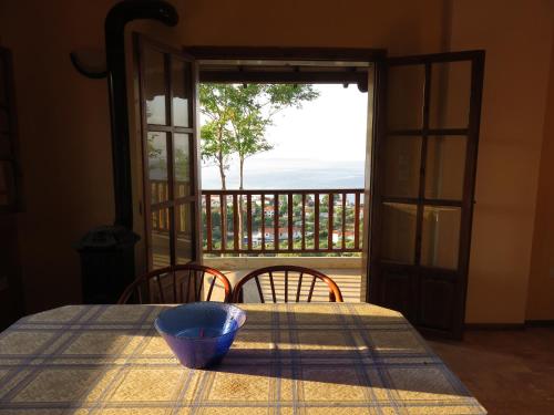 a table with a blue bowl on a table with a view at Best view in Polychrono - Families Only in Polychrono