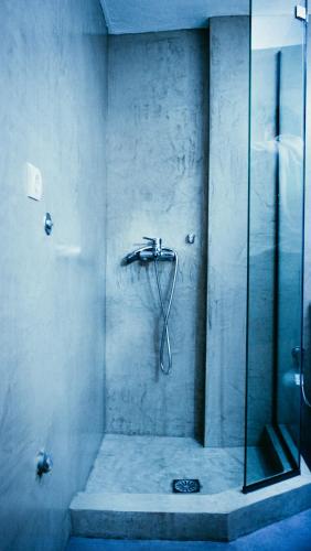 a shower with a glass door in a bathroom at Violet City Center Apartments in Kavála
