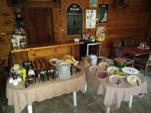 two tables with food on them in a restaurant at Penzion Rudolf in Liberec