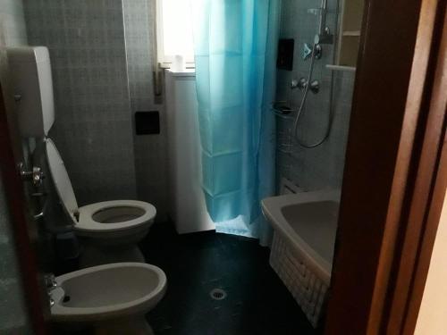 a bathroom with a toilet and a sink and a shower at Appartamento MiMa Pineta in Milano Marittima