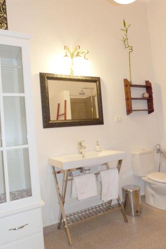 a bathroom with a sink and a toilet at La Casa de Vegueta in Las Palmas de Gran Canaria