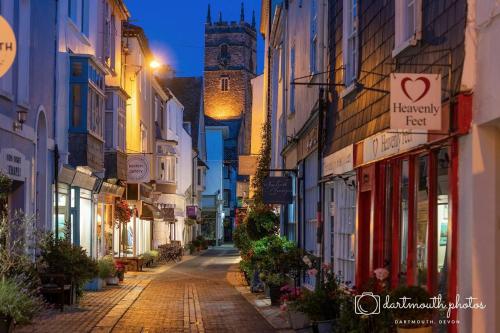 an empty street in an old town at night at The Old Brasserie & Rooms @ no.8 in Dartmouth