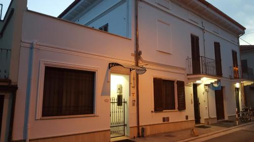 a white building with a window on a street at Orchidea Rooms & Suites in Civitanova Marche