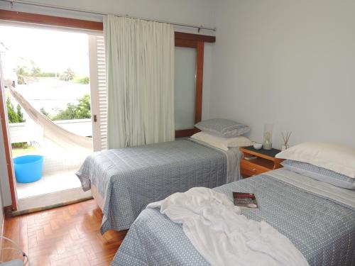 Un pat sau paturi într-o cameră la ATLÂNTIDA 210 , Xangri-lá RS