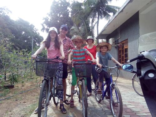 a group of people riding bikes on a path at Priyanna Guest, Forest view in Polonnaruwa