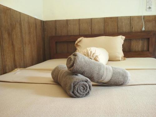 a stuffed animal is laying on a bed at Rumah Daun Homestay Tetebatu in Tetebatu