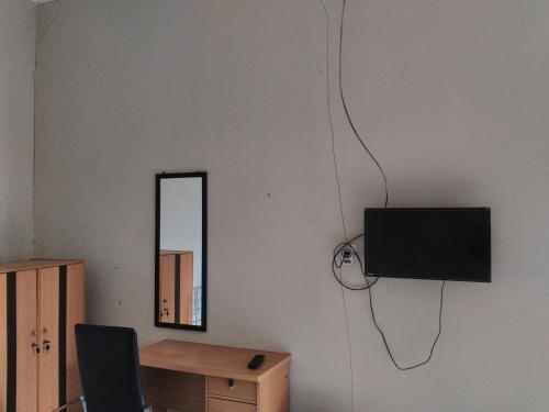 En TV eller et underholdningssystem på Nabila Syar'i Guest House