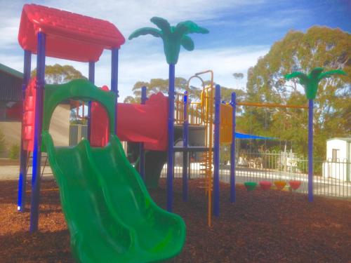 a playground with a slide in a park at Toora Tourist Park in Toora