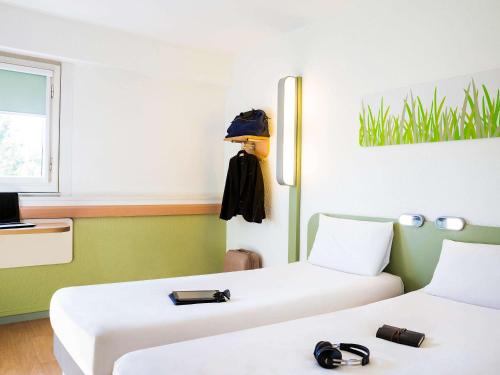 Tempat tidur dalam kamar di ibis budget Toulouse Centre Gare