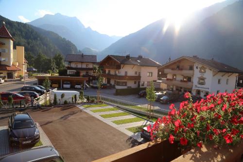 a view of a town with buildings and a parking lot at Hotel & Suites Glück Auf in Mayrhofen