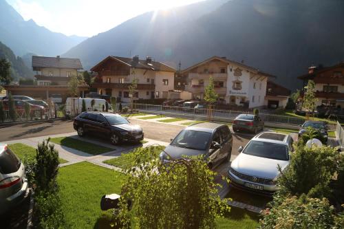 a group of cars parked in a parking lot at Hotel & Suites Glück Auf in Mayrhofen