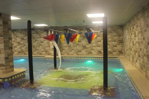 a swimming pool with a water slide in it at Marina Hotel in Rayyis