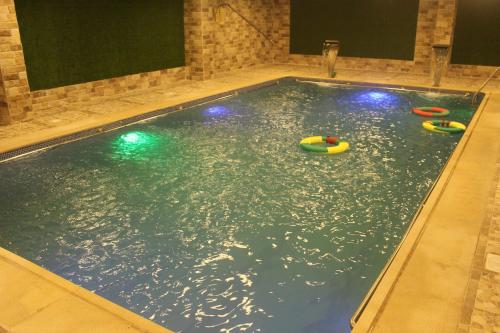 an indoor swimming pool with toys in the water at Marina Hotel in Rayyis