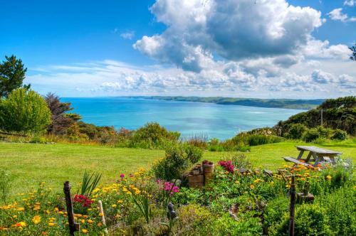 a garden with a view of the water at Solscape in Raglan