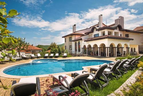 an estate with a swimming pool and lounge chairs at Boutique & Spa Hotel Heaven in Velingrad