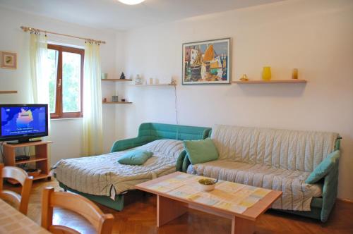 a living room with a couch and a coffee table at Apartment Branko with free parking in Ičići