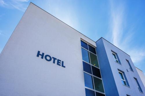 a hotel sign on the side of a building at Ibis Styles Charleroi Airport Aero 44 in Charleroi