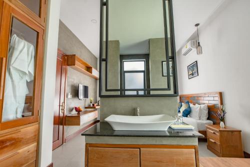 
a bathroom with a sink and a mirror at Krissna Villa Siem Reap in Siem Reap
