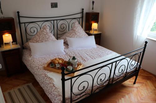 a bedroom with a bed with a tray of food on it at Fuchsheisl in Riedenburg
