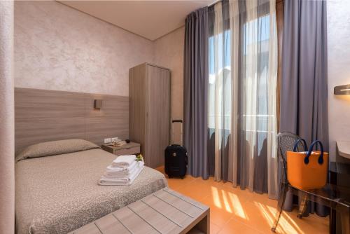 a hotel room with a bed and a window at Hotel Biancolilla in San Vito lo Capo