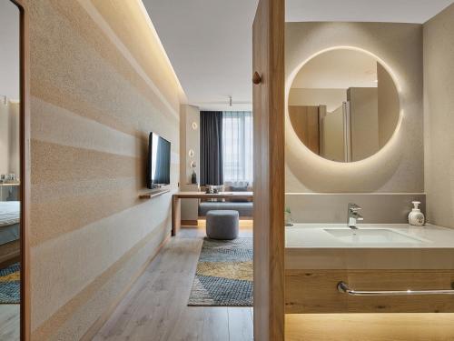 a bathroom with a sink and a mirror at EBO Hotel Hangzhou Wulin - 5 mins drive to the West Lake in Hangzhou