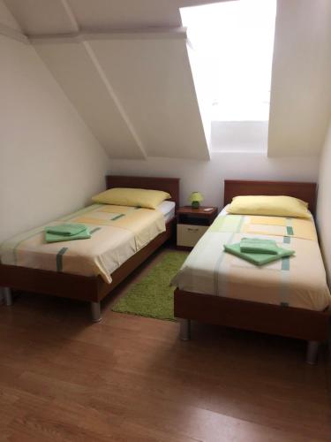 two beds in a room with a attic at Apartment Kate in Dubrovnik