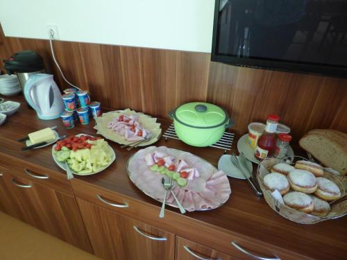 a counter with many plates of food on it at Penzion Ječmínek in Červená Voda