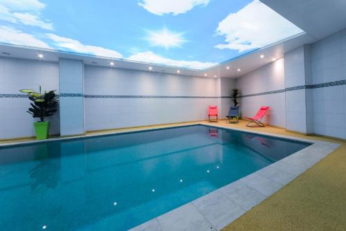 a swimming pool with a skylight in a building at Golden Star Casablanca in Casablanca