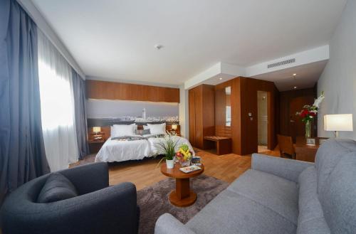 a hotel room with a bed and a living room at Golden Star Casablanca in Casablanca