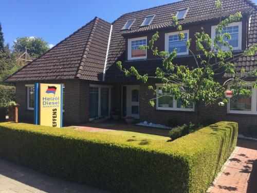 a house with a sign in front of it at Haus Steffens in Esens