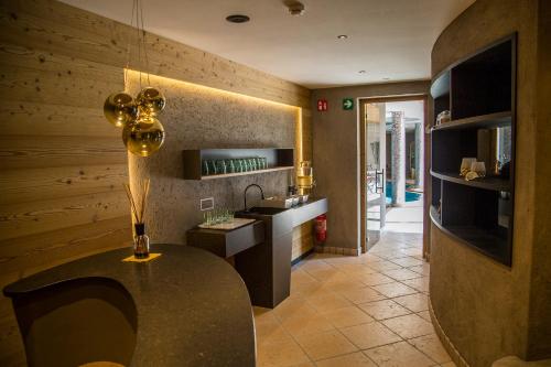 a kitchen with a table in the middle of a room at Hotel Welponer in Selva di Val Gardena