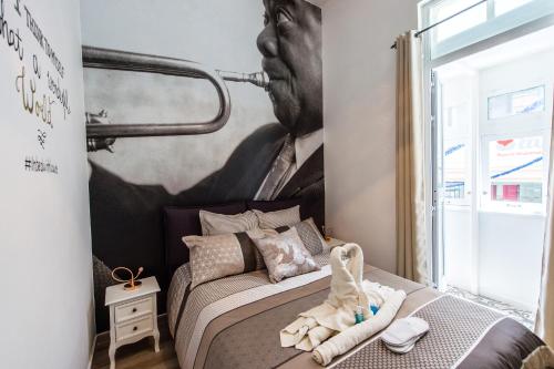 a bedroom with a mural of a man on the wall at Backstage Boutique Music Themed Townhouse in Sliema