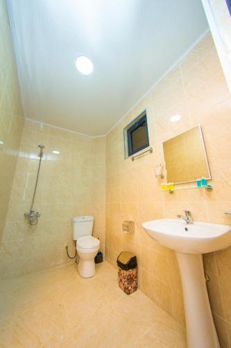 a bathroom with a sink and a toilet at Hotel Gori in Kobuleti