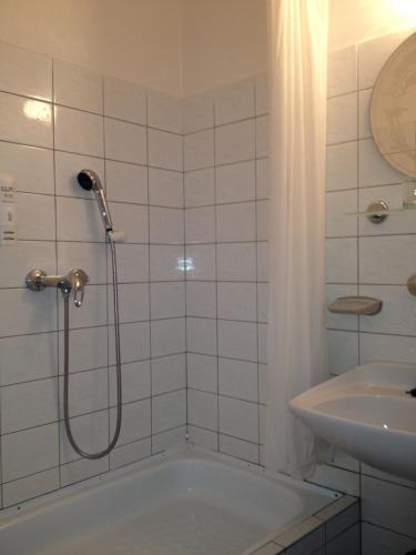 a bathroom with a shower and a tub and a sink at Pension Filip in Prague