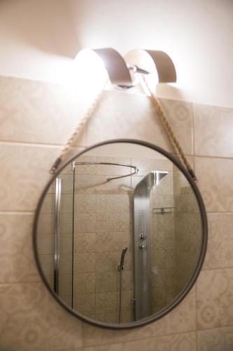 a mirror in a bathroom with a shower at Attico in Canicattì