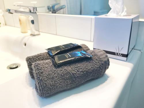 a wallet sitting on top of a bathroom sink at Avalon Manor Motel in Motueka