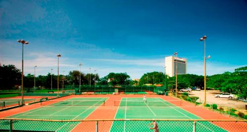 a tennis court with two people playing on it at The Liguanea Club in Kingston