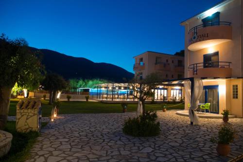 a night view of a building with a patio at Akroyiali Resort in Vasiliki