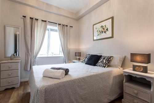 a bedroom with a bed and a window at St Patricks Cathedral Self Catering in Dublin