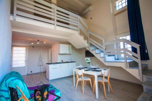 a kitchen and a dining room with a loft at Garda Friends Apartments in Toscolano Maderno