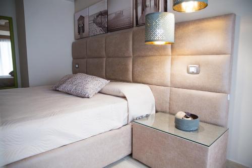 a small bedroom with a bed and a table at Attico in Canicattì