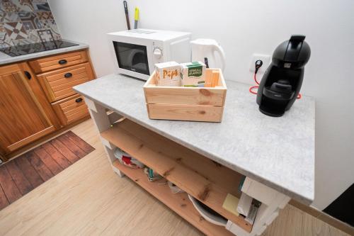 a kitchen with a counter with a microwave on it at Basalto Negro AL in Angra do Heroísmo