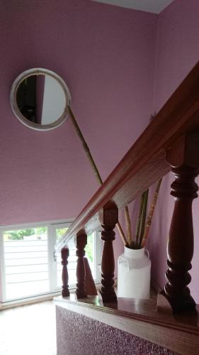 a table with a lamp and a mirror on a wall at Pensión NAVIA A Pontenova in A Pontenova