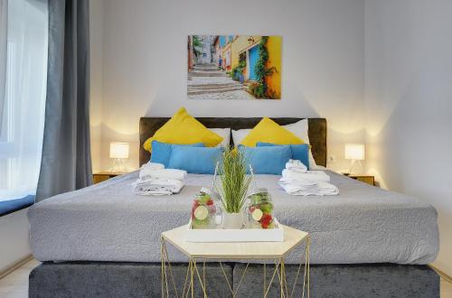 a bedroom with a large bed with a table at D&A Amphitheatre Apartments with free parking in Pula