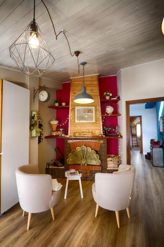a living room with two chairs and a fireplace at Il Piccolo Tibet - Gran Sasso in LʼAquila